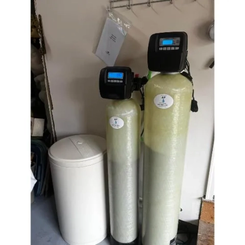 AP Water Treatment twin-tank water softener and filtration system with control valves and brine tank.