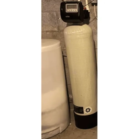 Professional whole-house water conditioning installation in a residential basement utility zone by Apple Plumbing, Heating & Air