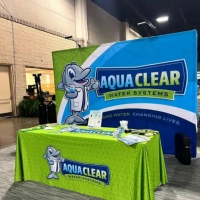 Aqua Clear Water Systems event booth advertising filtered water solutions and water softeners.