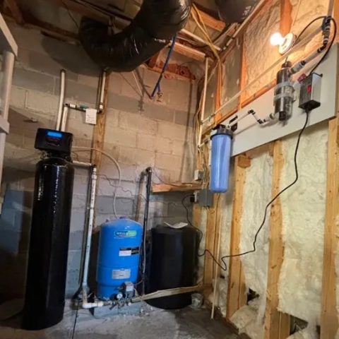Aqua Solve NC Water Softener system installed in a basement with blue Well-X-Trol pressure tank.