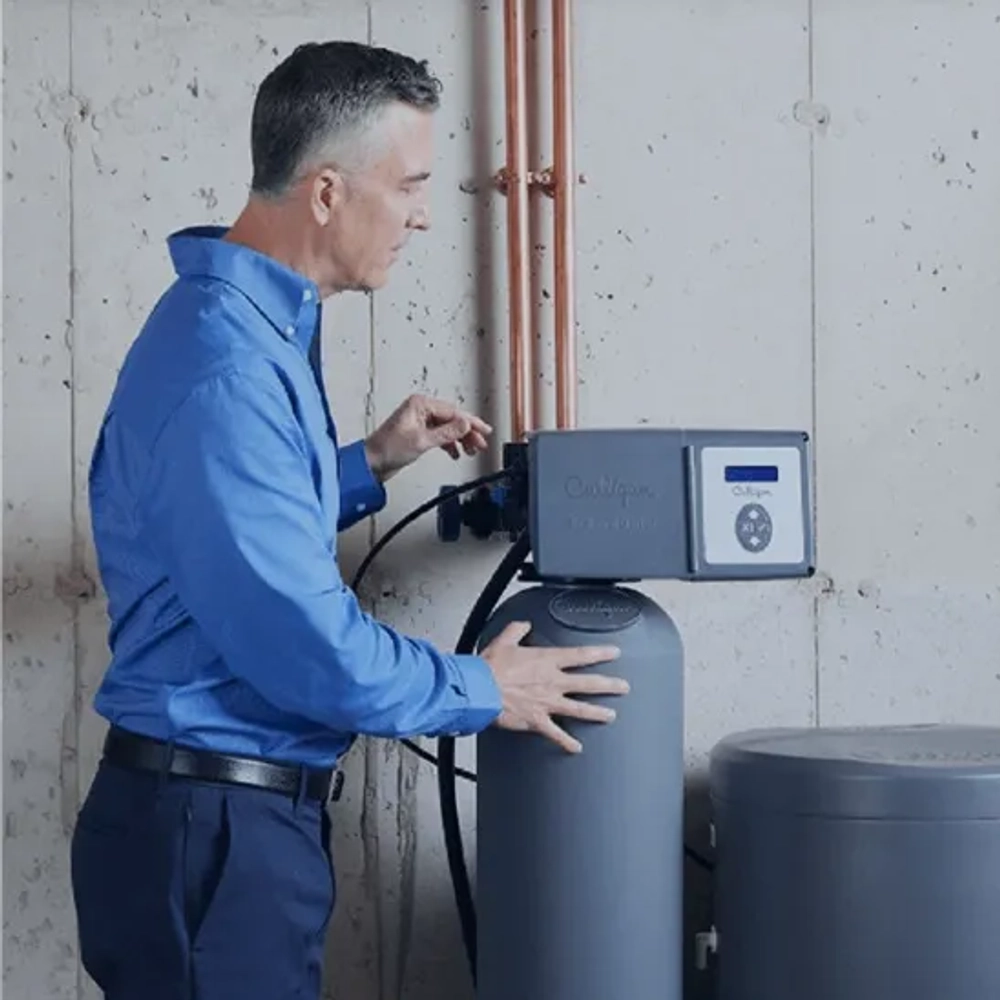 Culligan technician servicing the Aquasential Smart HE water softener in a residential basement.