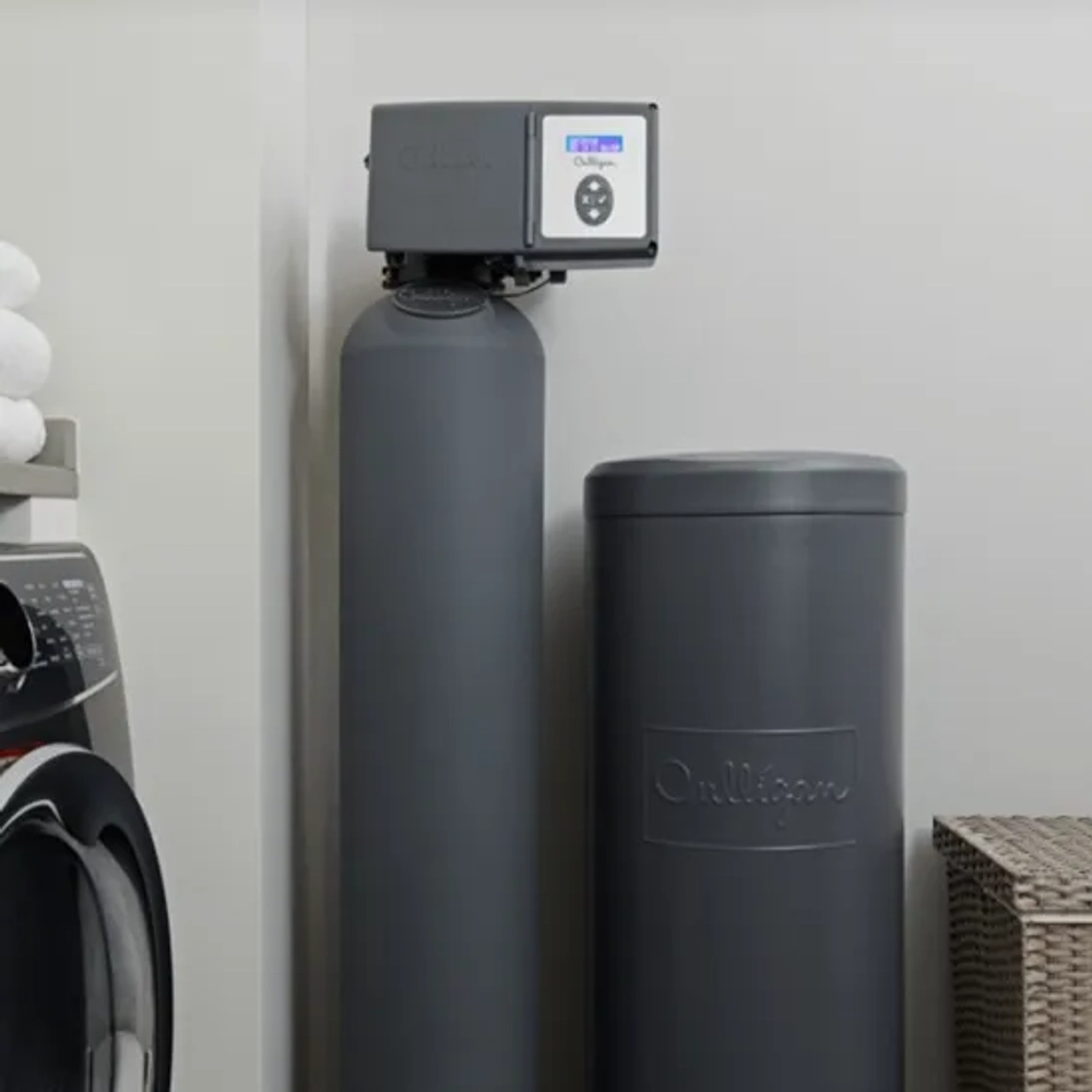 Culligan Aquasential Smart HE water softener installed in a laundry room next to a washer.