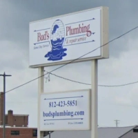 Bud's Plumbing & Repair Service sign for same day service with logo illustration.