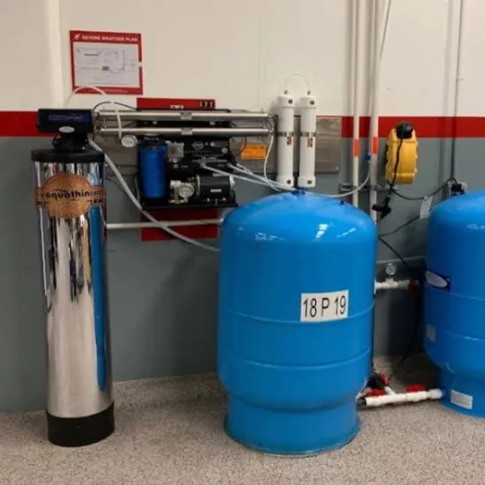 Plumbing installation: A water purification system featuring a softener, pressure tanks, and wall-mounted RO unit.