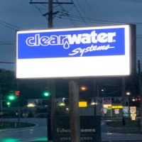 Clear Water Systems company sign on a pole, advertising water treatment and purification services.