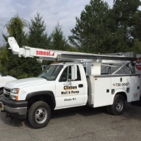 Clinton Well & Pump boom truck with Smeal crane, used for deep well pump repair and water treatment.