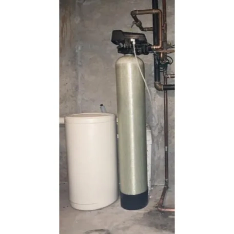 Water softener system by Clinton Well and Pump, featuring a fiberglass tank and separate brine tank in a utility space.