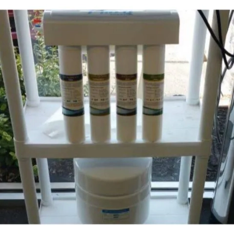 Dierolf Plumbing & Water Treatment reverse osmosis system with 4-stage filters and storage tank.