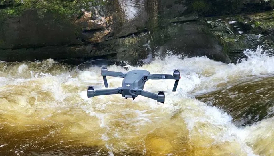 Conceptual illustration depicting various drone types in different water resources management scenarios, such as monitoring rivers, reservoirs, and agricultural fields