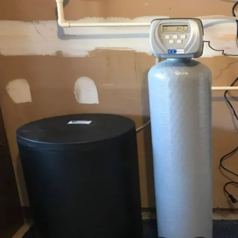 Professional metered water conditioner system expertly installed in a utility space by e Water Company