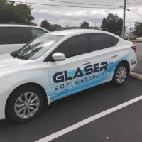 Side view of the Glaser SoftWater, Inc. company vehicle showing the logo and water quality branding wrap.