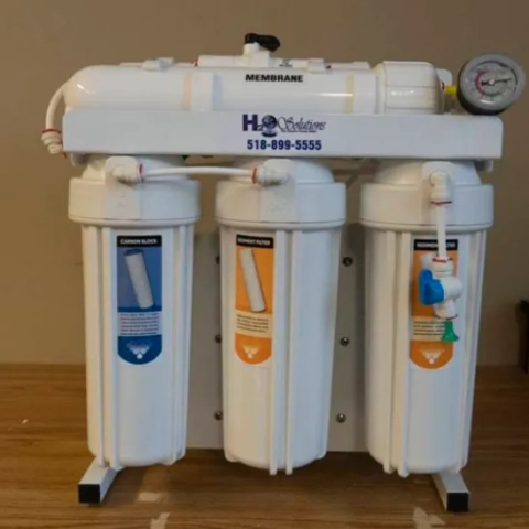 Under-sink reverse osmosis filtration unit from H2O Solutions with vertical sediment and carbon canisters
