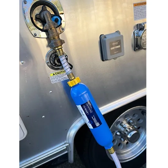 GLACIER FRESH Inline Water Filter is connected to a RV with reliable hose protector.