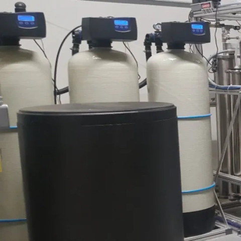 Professional multi-tank continuous-flow industrial water softening skid calibrated to treat bulk process water volumes and neutralize scaling minerals, manufactured by HydroMax Inc