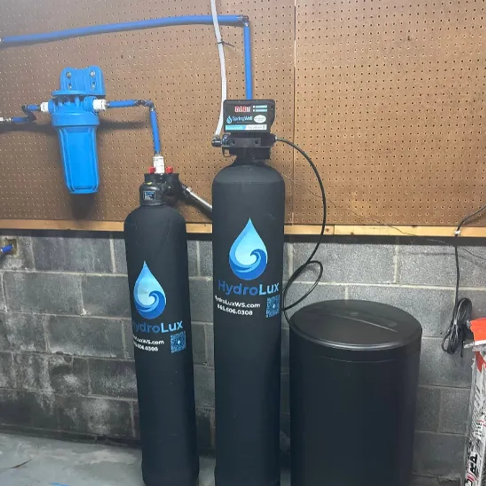 Residential HydroLux Signature Series water treatment system with logo and control valve.