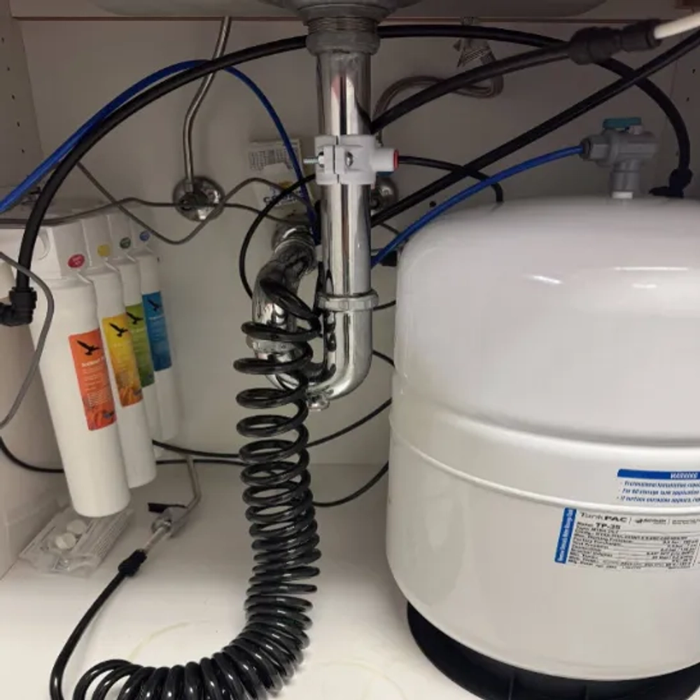 Installed Hydrophilic RO/DI (Reverse Osmosis Deionization) water filtration system under sink with tank.