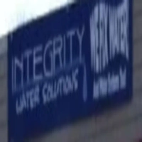 Integrity Water Solutions logo on a dark blue building sign featuring a thin white uppercase wordmark with a stylized droplet dropping from the letter "Y"