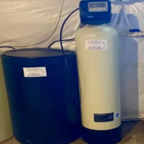 Professional home water conditioning tank with an automated electronic control valve installed by Integrity Water Solutions