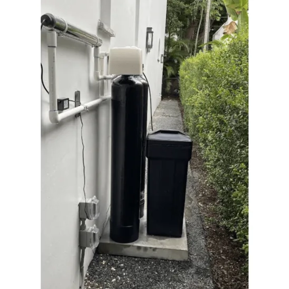 Outdoor Life Filtration setup with dual black tanks, square brine tank, and UV water sterilizer