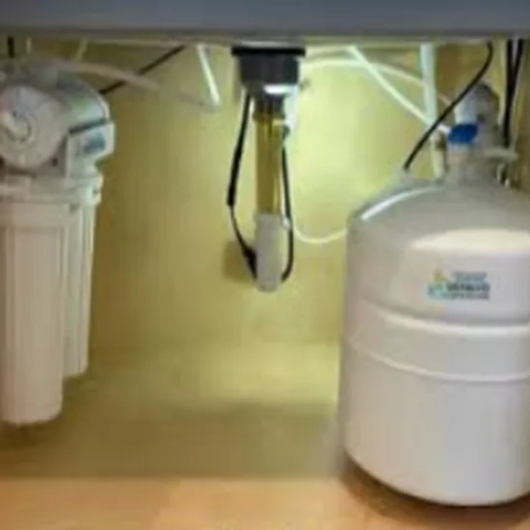 Streamlined under-counter residential reverse osmosis layout designed to fit around complex kitchen plumbing and maximize cabinet utility storage, available from Mermaid Water Systems Inc