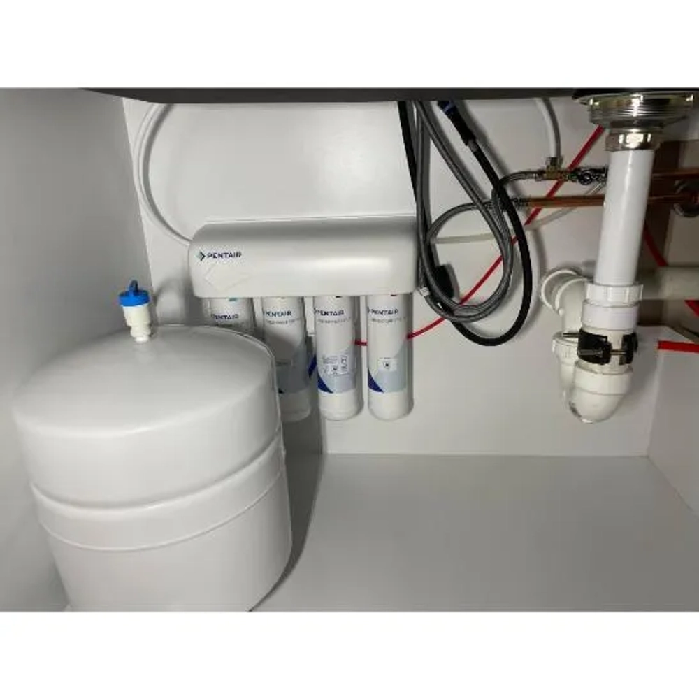Installed Pentair FreshPoint GRO-475 Reverse Osmosis system and storage tank under a kitchen sink.
