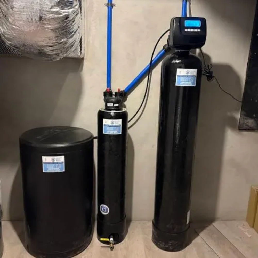 Prestige Water Group installed black residential water softener system with brine tank and digital control head.