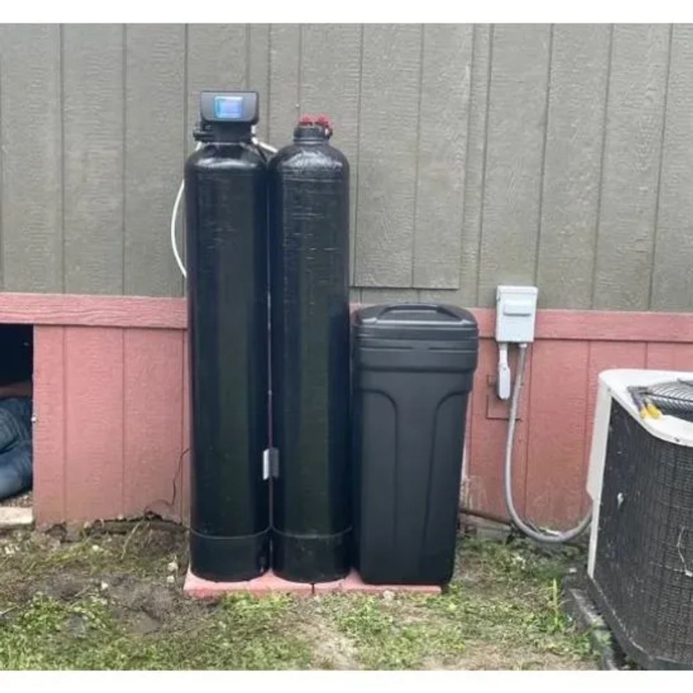 Pro Clean PCC Water Filtration system installed outdoors with two black tanks and brine tank