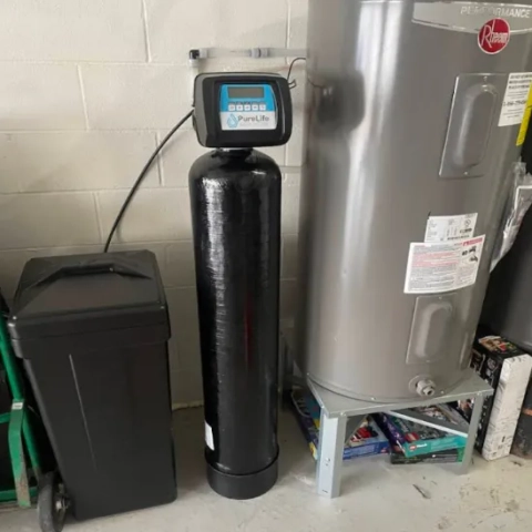 Full installation view of the PureLife Water Softener system in a garage setting with utility tank.