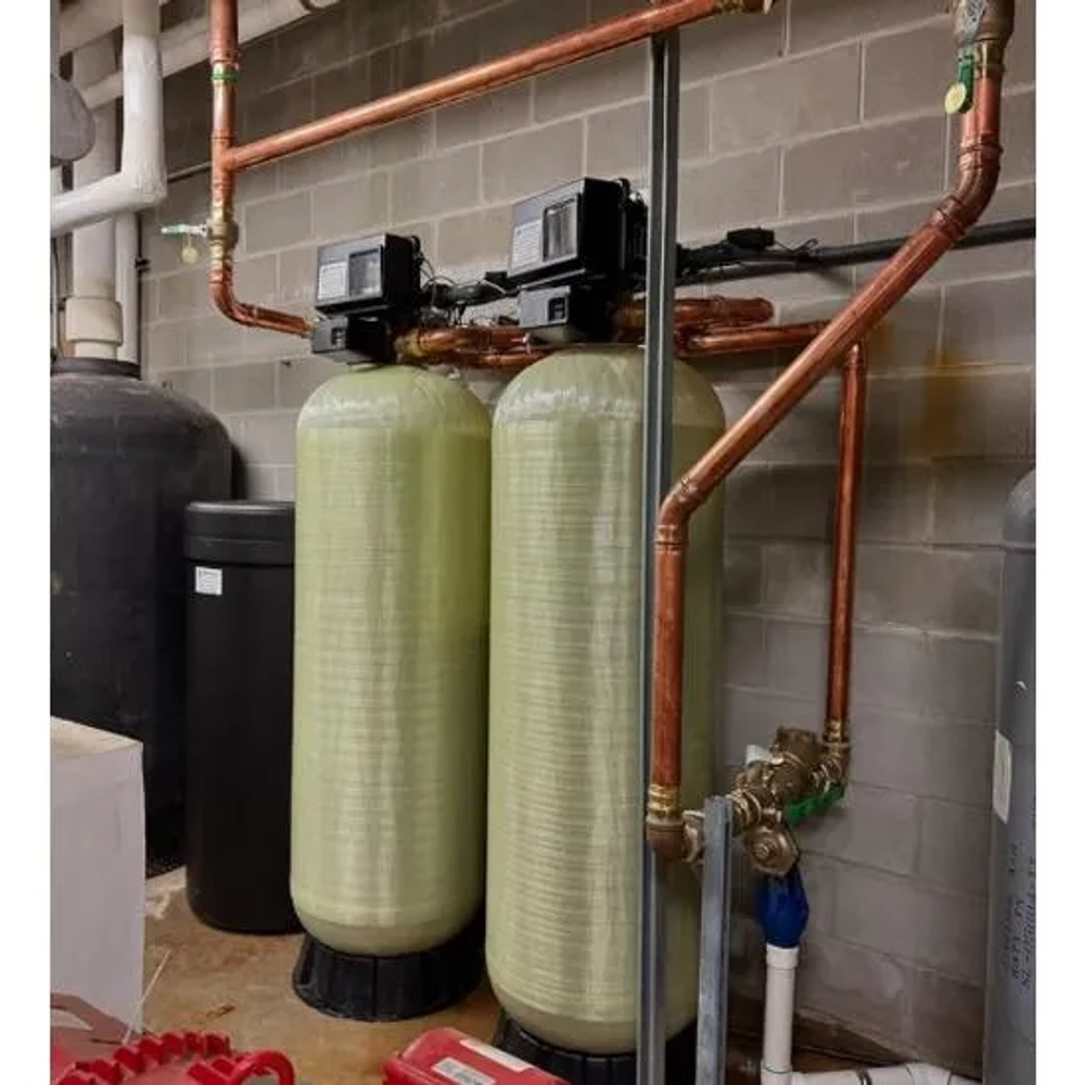 Rainbow Water Purification industrial water softener system with dual tanks and copper plumbing in Houston.