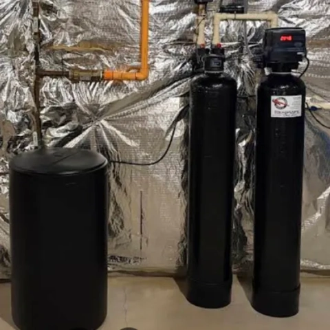 Household ion-exchange water conditioning system cleanly integrated into a residential utility room by Reed and Son Services LLC