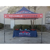 Reliable Services USA trade show tent, red and blue branding, offering home improvement and repair.