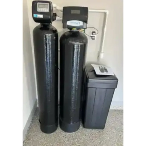 Reliable Water Service twin-tank water softener with black resin tanks and brine tank installed