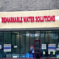 Remarkable Water Solutions storefront, displaying water filters, drinking water, and maintenance services.