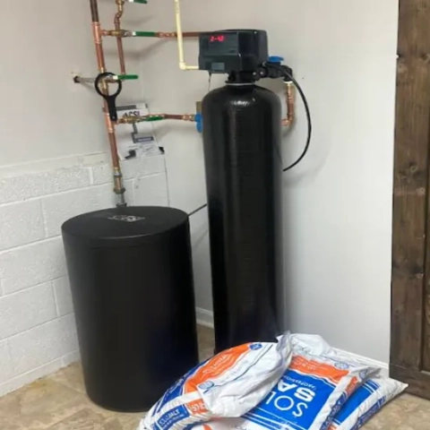 Professional single-tank household water conditioning system cleanly integrated into a utility area by SJ Johnson Inc