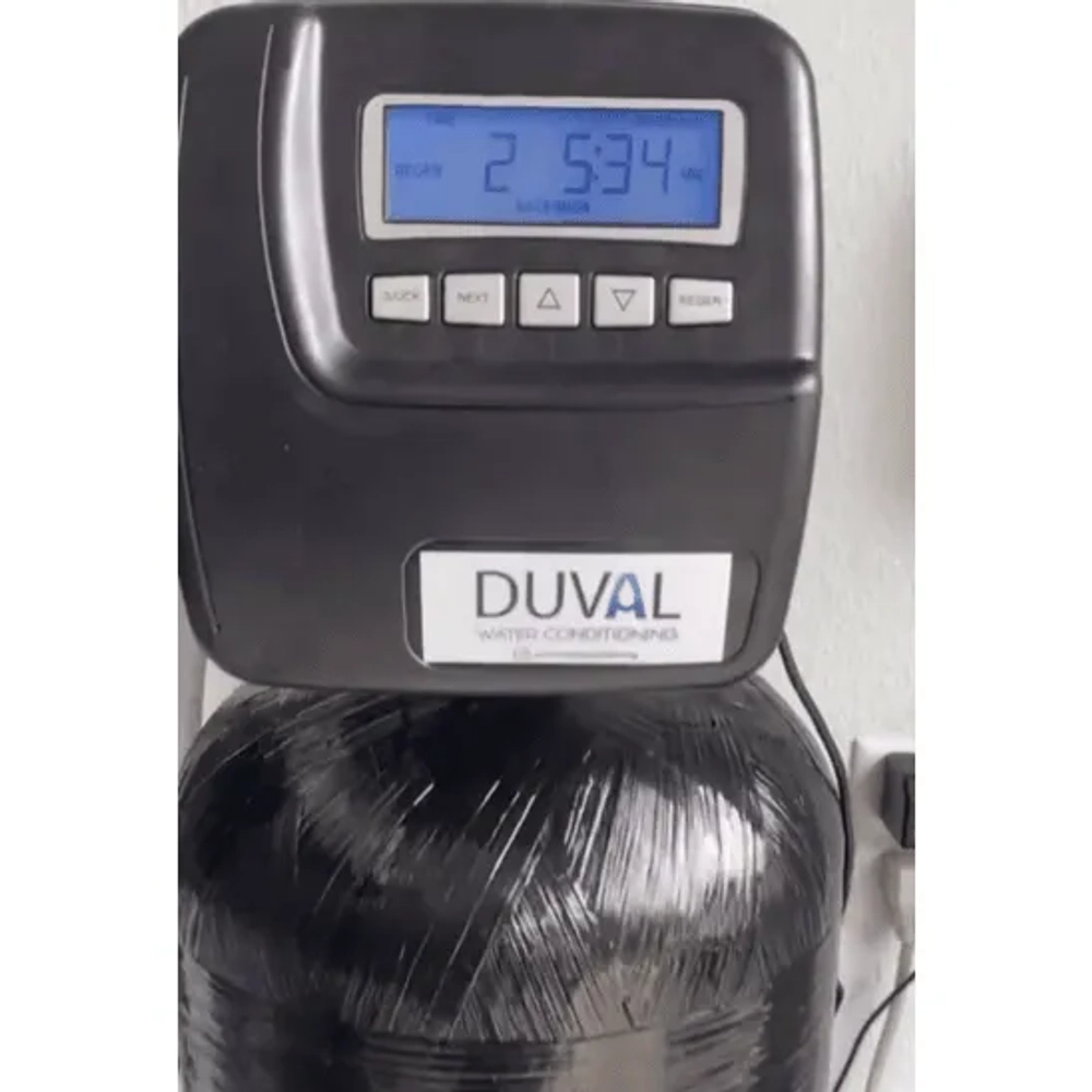Close-up of the DUVAL Water Conditioning digital control head showing regeneration time