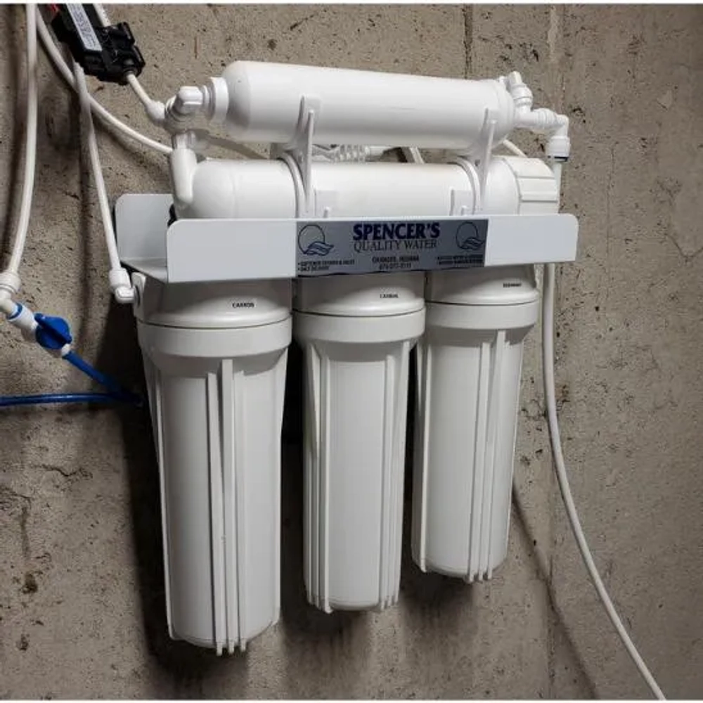 Spencer's Quality Water under-sink RO filter manifold with carbon pre-filters and housing.