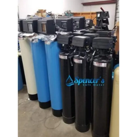 Spencer's Soft Water company warehouse showing large inventory of residential water treatment systems.