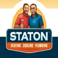 Staton logo featuring an illustration of two smiling service technicians with a wrench in front of a sunrise backdrop, above a navy and orange badge reading "STATON HEATING COOLING PLUMBING"