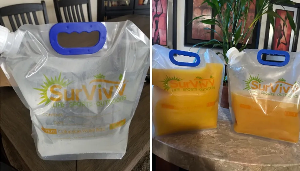 A strong and flexible SurVivv Premium Collapsible Water Container Bag is filled with orange juice.