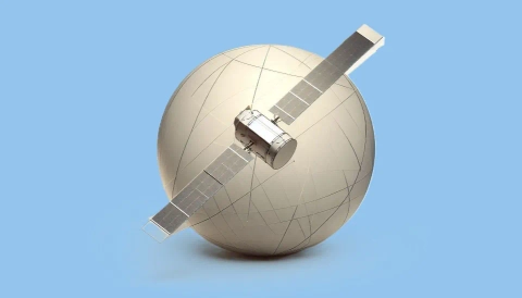 3D rendering of a small satellite with solar panels positioned against a large, grid-patterned globe.