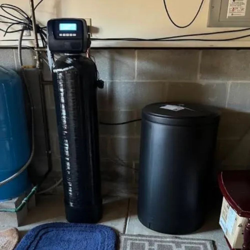 The Softener Guy water treatment unit and salt tank, featuring a digital control head for home use.