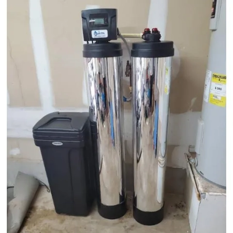 The Water Man Water Softener with two mineral tank and a black brine tank.