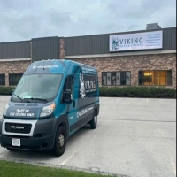 Viking Bath & Kitchen Milwaukee company van outside building offering custom cabinets and plumbing.