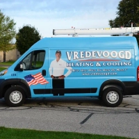 Fleet of Vredevoogd Heating & Cooling service vehicles for HVAC repair in Grand Rapids, MI.