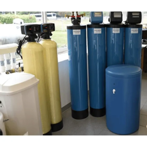 Water Filter Co Inc residential water softener systems and filtration tanks in a showroom setting