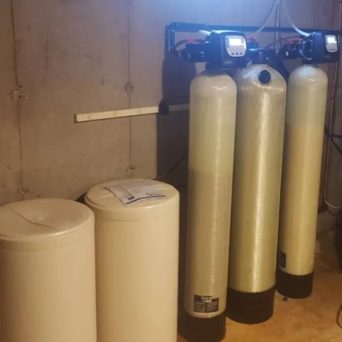 Water Filtration Experts commercial-grade water softener system installation in a residential basement