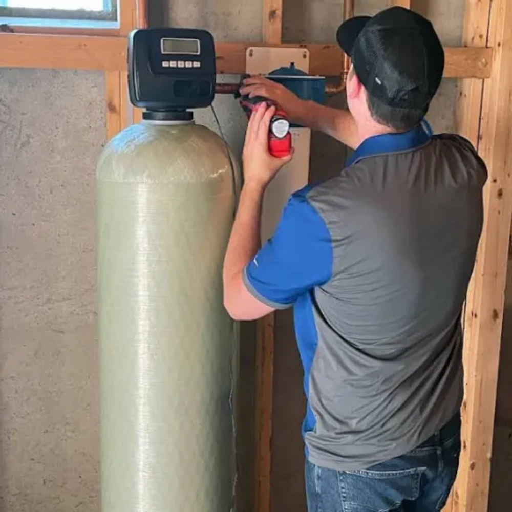 Water Geeks LLC residential water softener system with digital display and copper plumbing installation