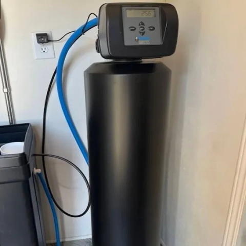 Benjamin Franklin Plumbing black water softener tank with digital control head for home filtration.