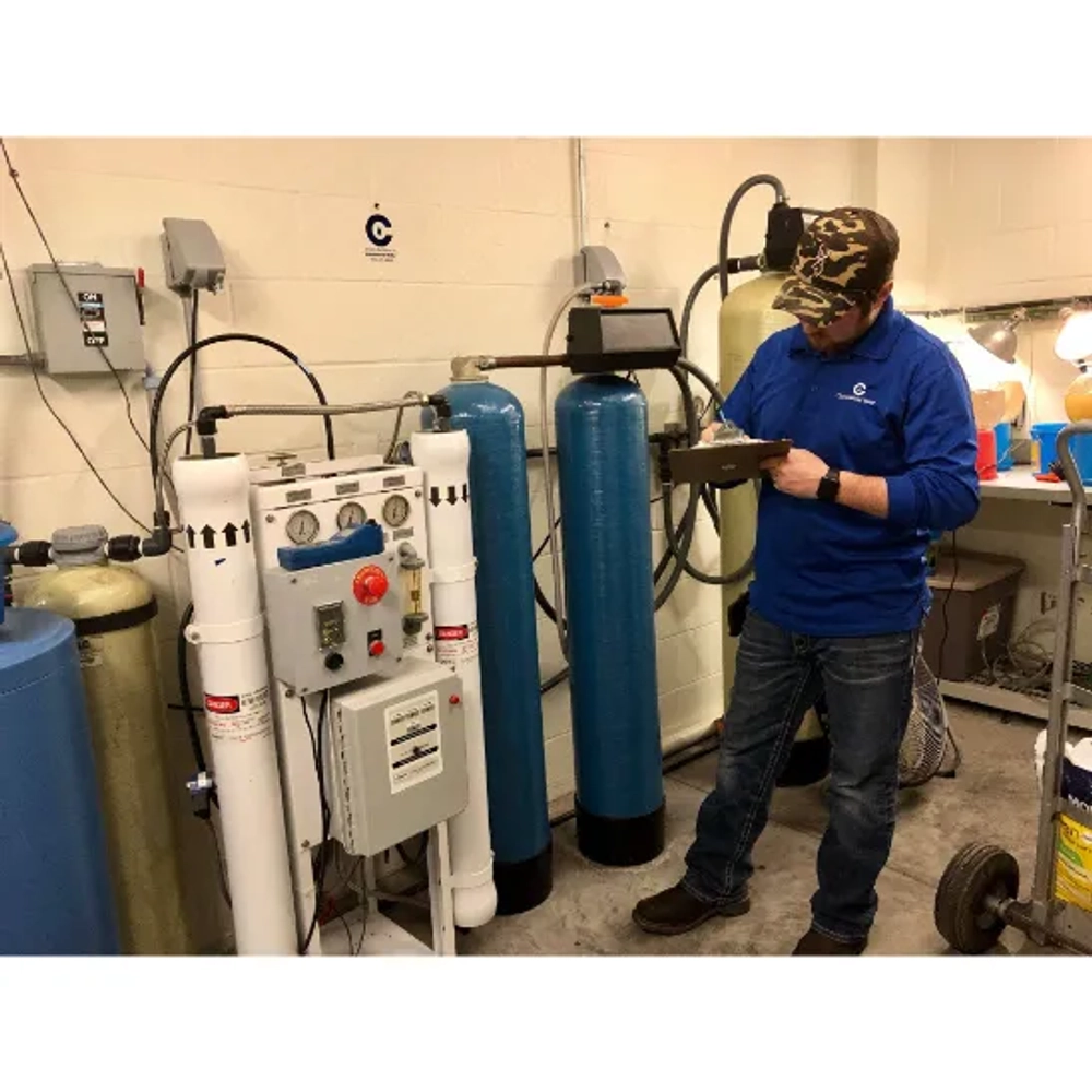 Commercial Water technician inspecting an industrial reverse osmosis and water softener system.