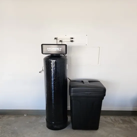 Honest Water Co branded water softener and brine tank system installed in a Raleigh garage.